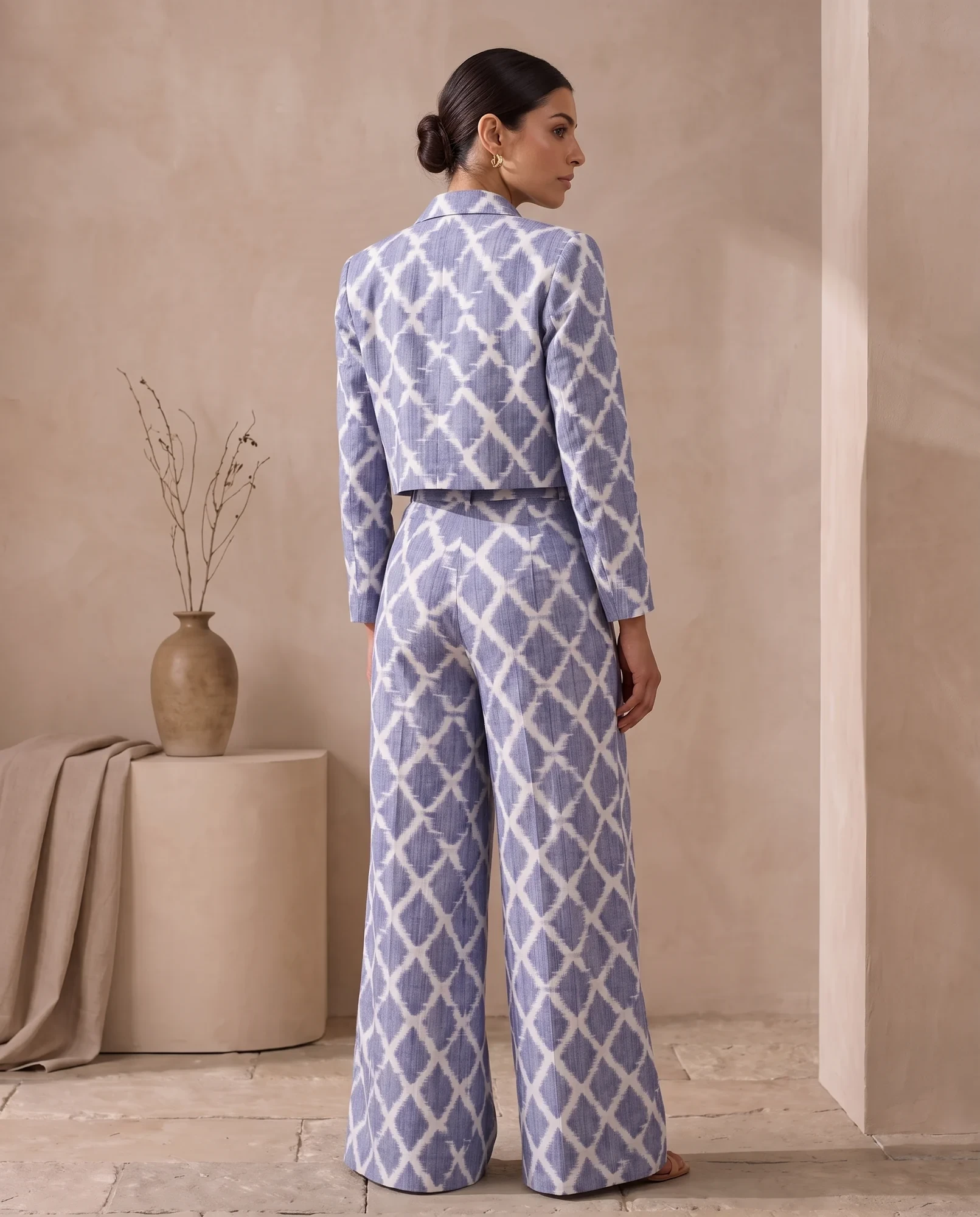 Back three-quarter view of the periwinkle ikat cropped jacket and wide-leg trousers