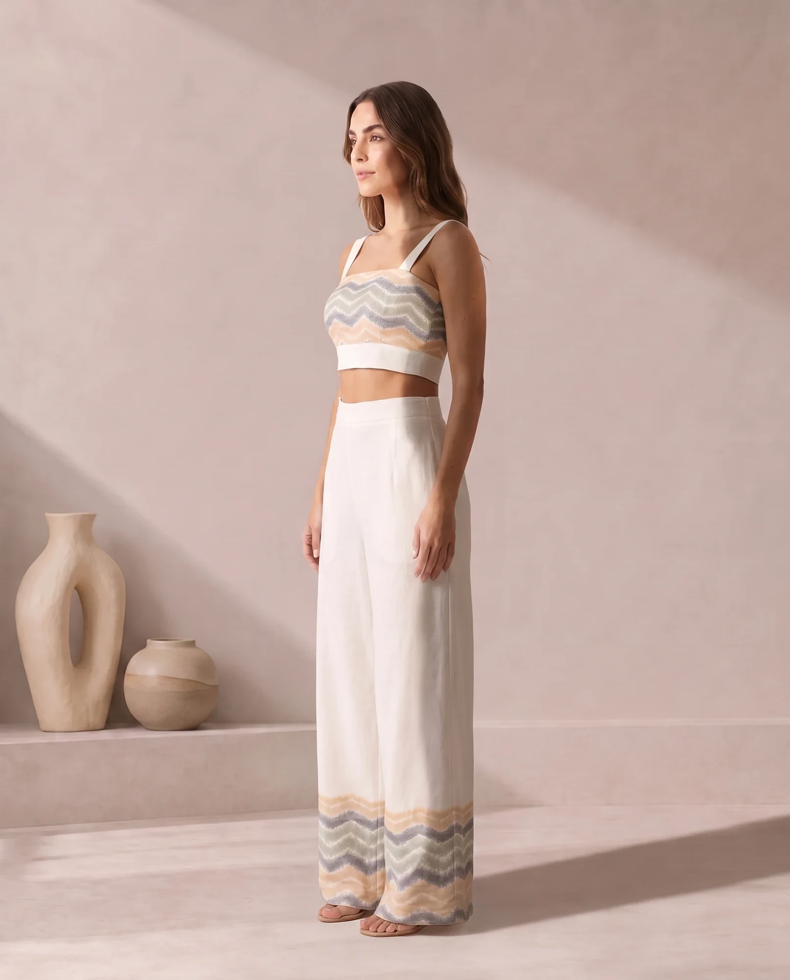 Three-quarter view of the ivory bandeau co-ord, showing the wide straps and chevron ikat band