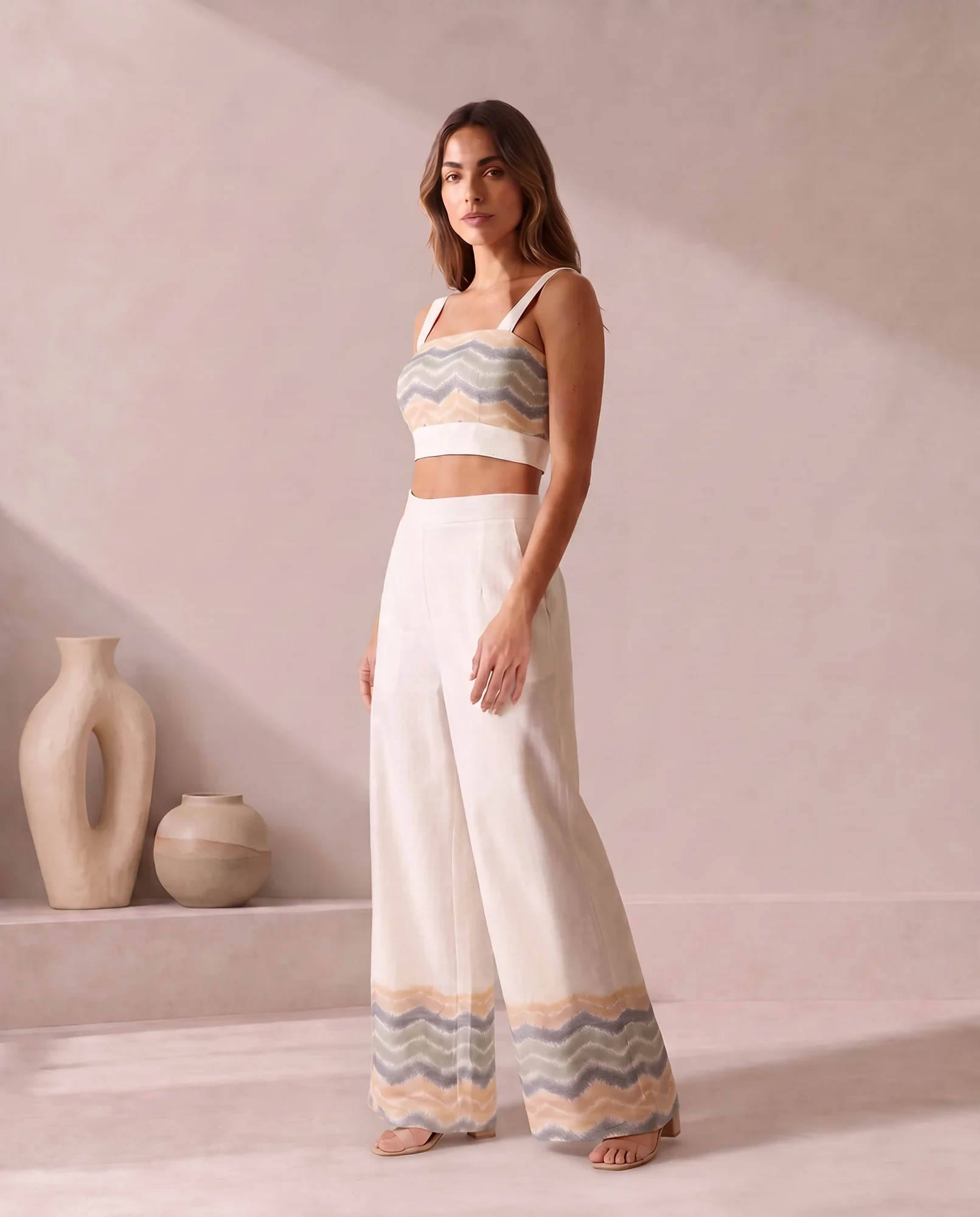 Three-quarter view of the ivory co-ord set with the chevron ikat trouser hem