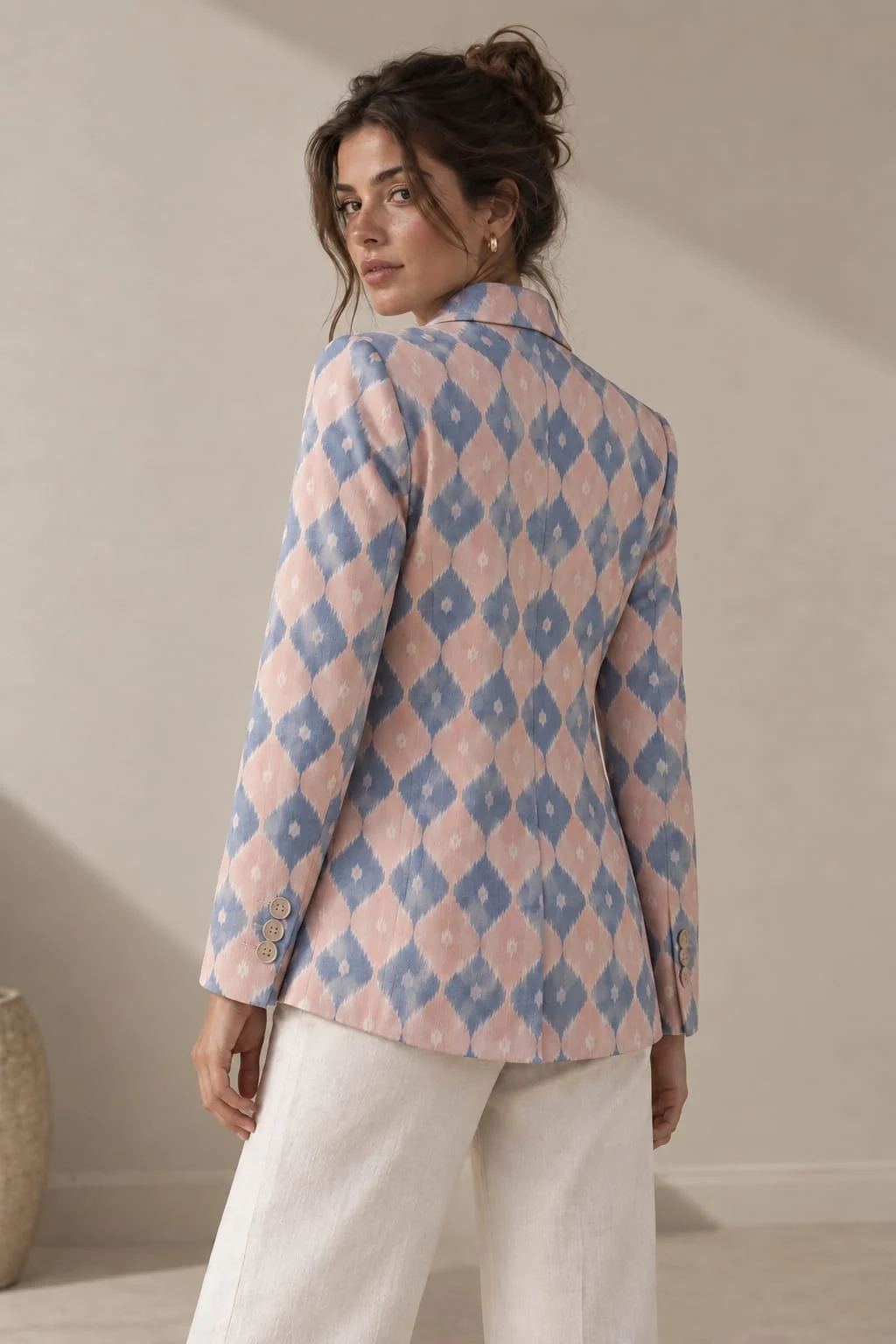 Three-quarter back view of the dusty rose ikat blazer with buttoned cuff
