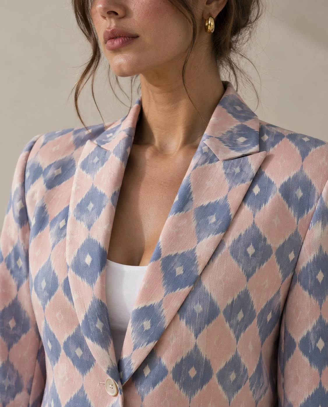 Close-up of the peak lapel and diamond ikat weave of the dusty rose blazer